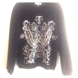 Black pullover with cream scroll design on front